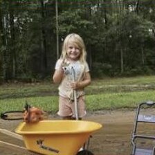 One of the kids helping out with a wheelbarrow